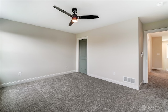 unfurnished room with ceiling fan and carpet