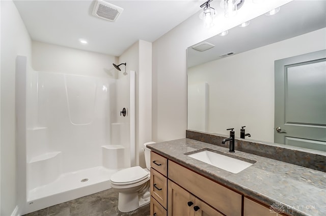 bathroom with vanity, toilet, and walk in shower