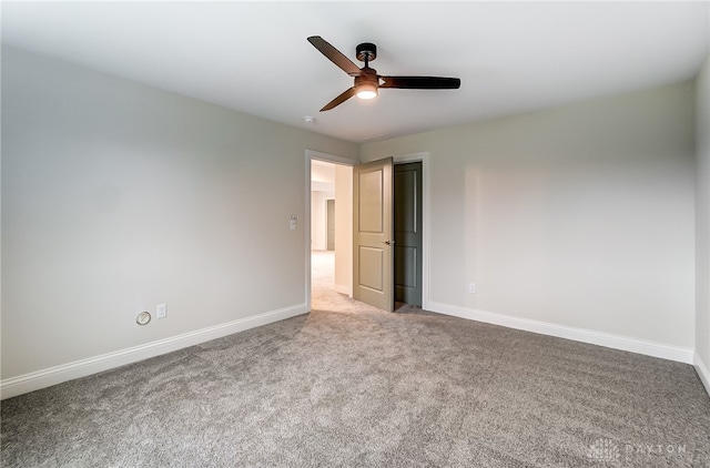 empty room featuring ceiling fan and carpet floors