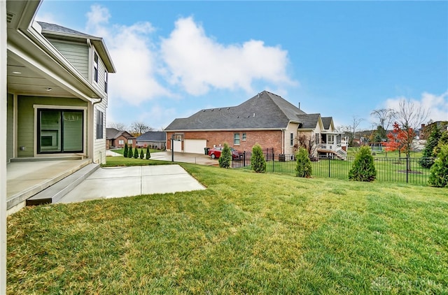 view of yard featuring a garage and a patio area