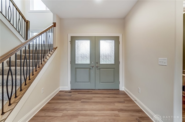 entrance foyer featuring light hardwood / wood-style flooring and french doors