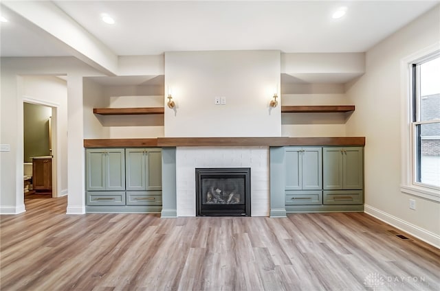 interior space featuring light wood-type flooring, plenty of natural light, and green cabinets