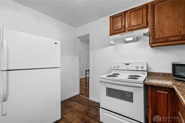 kitchen featuring a textured ceiling, white appliances, and dark hardwood / wood-style flooring