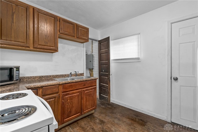 kitchen featuring sink, dark wood-type flooring, and range