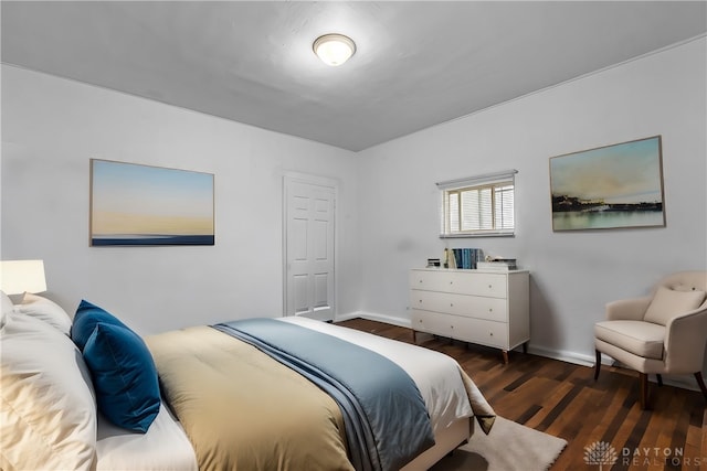 bedroom with dark hardwood / wood-style flooring