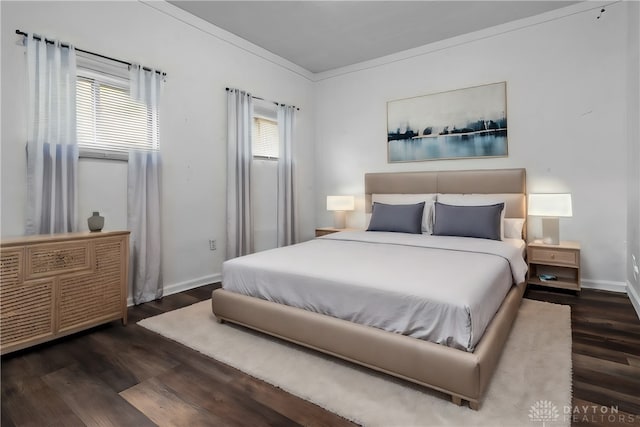 bedroom featuring crown molding, multiple windows, and dark hardwood / wood-style floors