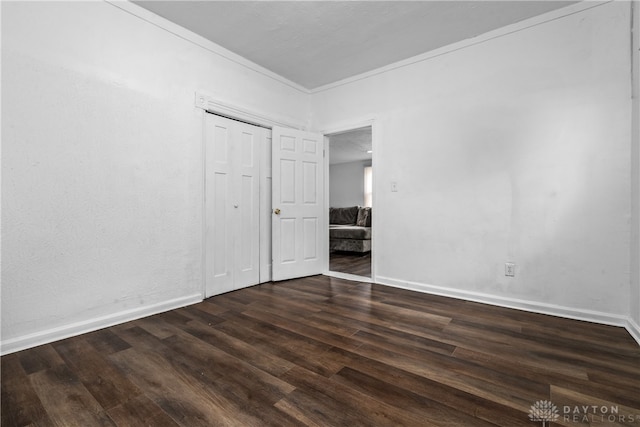 unfurnished bedroom featuring dark wood-type flooring