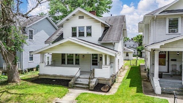 view of front of property with a porch and a front lawn