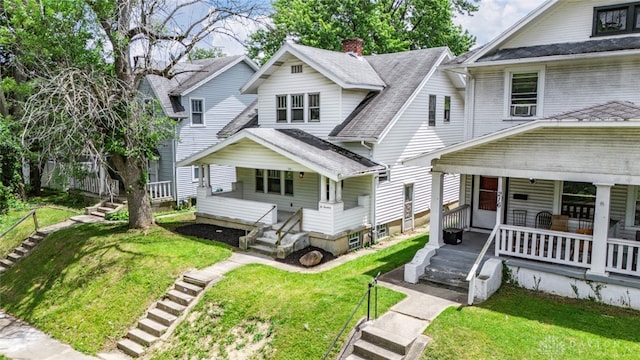 view of front of property with covered porch and a front yard