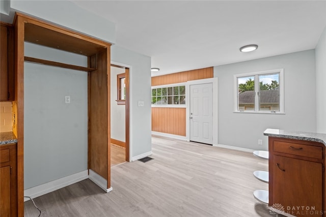 interior space featuring light hardwood / wood-style flooring and wood walls