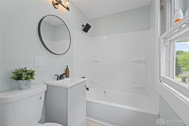 full bathroom featuring vanity, toilet, and washtub / shower combination