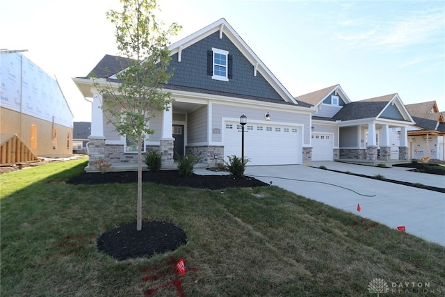 craftsman inspired home with a garage and a front yard