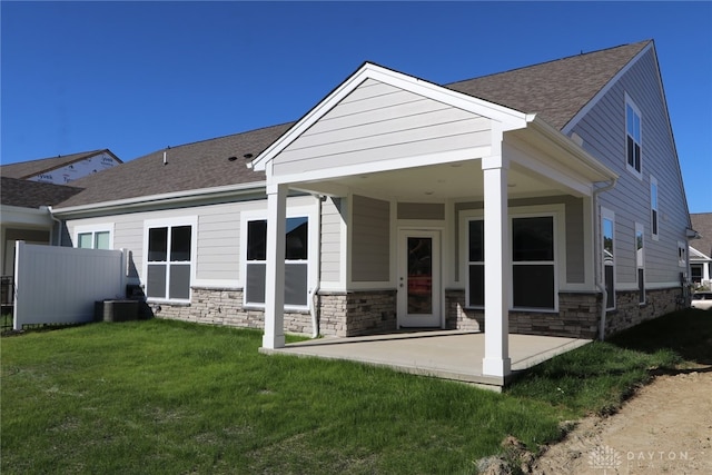 rear view of house with a yard, central AC, and a patio