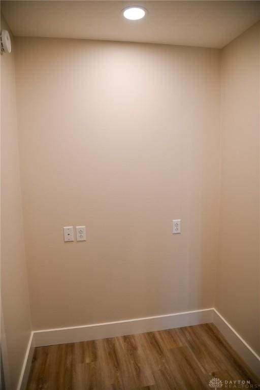 spare room featuring baseboards, recessed lighting, and wood finished floors
