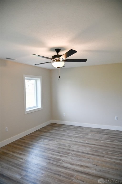 spare room with ceiling fan and wood-type flooring