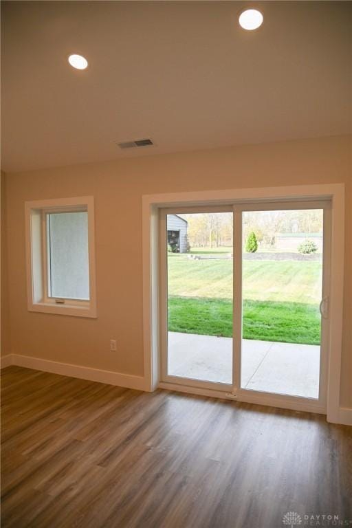 entryway featuring baseboards, recessed lighting, wood finished floors, and visible vents