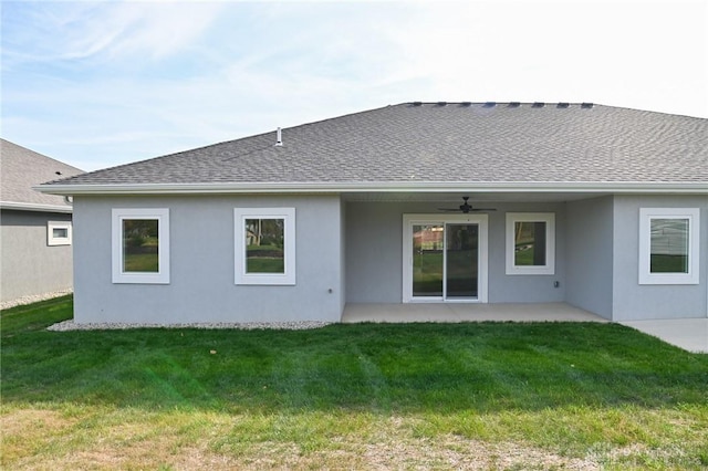 back of house with ceiling fan, a shingled roof, and stucco siding