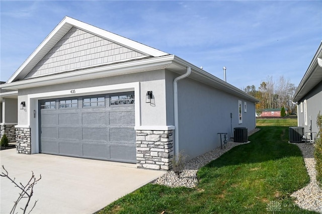 view of home's exterior with stone siding, stucco siding, concrete driveway, central air condition unit, and a yard