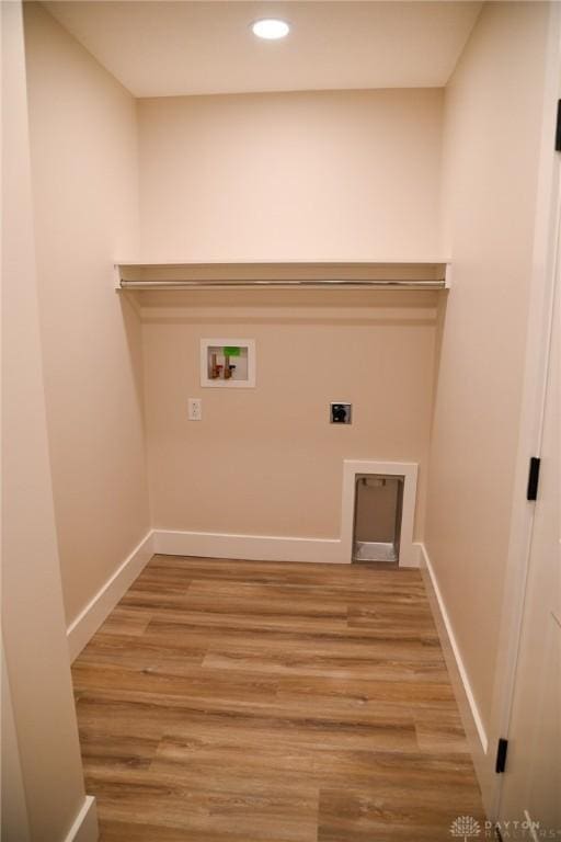laundry room featuring baseboards, hookup for a washing machine, recessed lighting, electric dryer hookup, and light wood-style flooring
