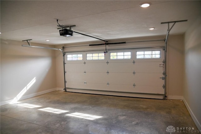 garage featuring recessed lighting, baseboards, and a garage door opener