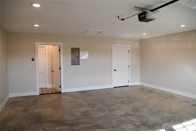 garage with a garage door opener and electric panel