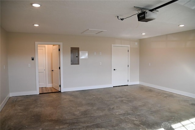 garage with recessed lighting, baseboards, a garage door opener, and electric panel