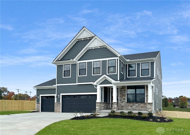 craftsman-style home with a front lawn and a garage