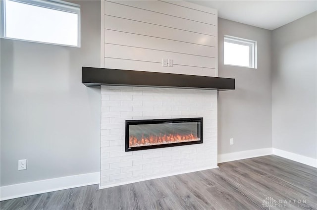 interior details with hardwood / wood-style flooring and a brick fireplace