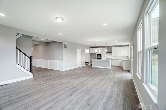 unfurnished living room with light hardwood / wood-style floors