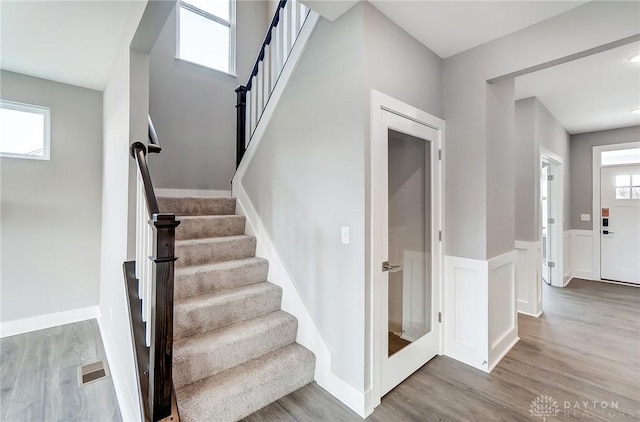 staircase with hardwood / wood-style floors