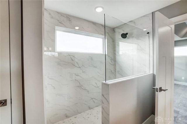 bathroom with tiled shower