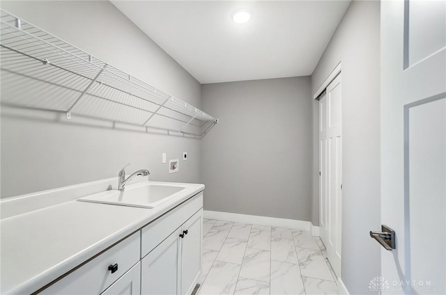 washroom with electric dryer hookup, sink, hookup for a washing machine, and cabinets