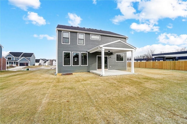 rear view of house with a patio area and a lawn