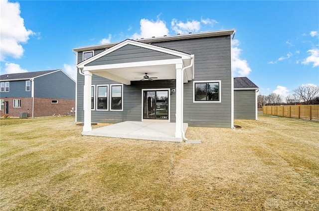 rear view of house with central air condition unit, a patio area, ceiling fan, and a lawn