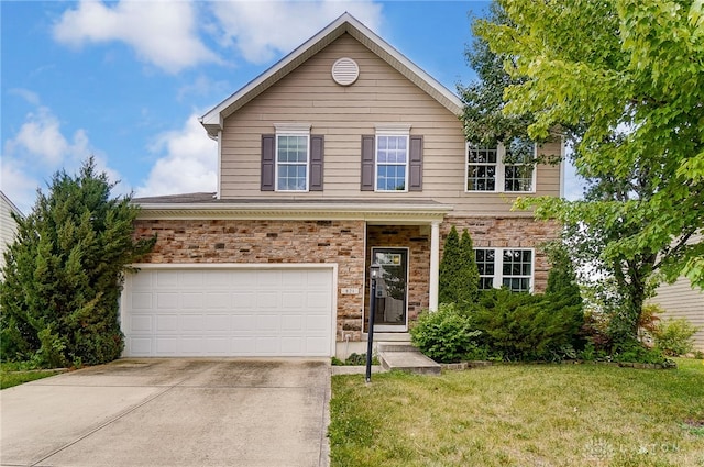 view of property with a garage and a front yard