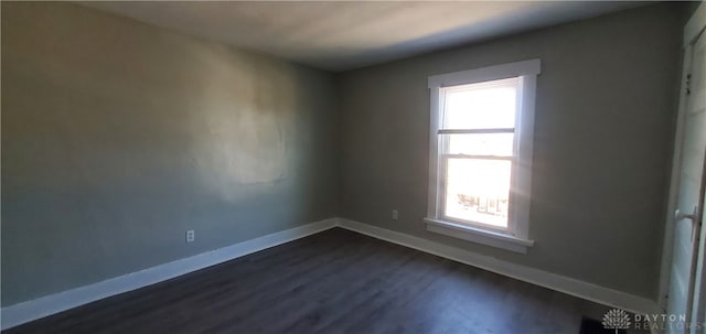 unfurnished room with dark hardwood / wood-style flooring