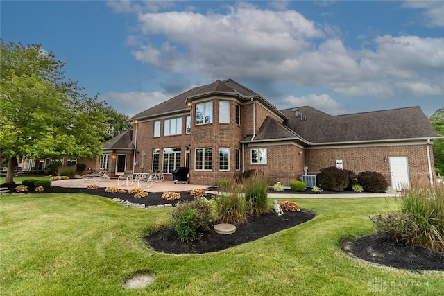 back of house with a yard, a patio area, and central air condition unit