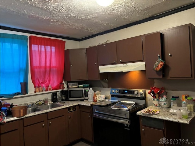 kitchen featuring stainless steel appliances, a textured ceiling, light countertops, under cabinet range hood, and a sink