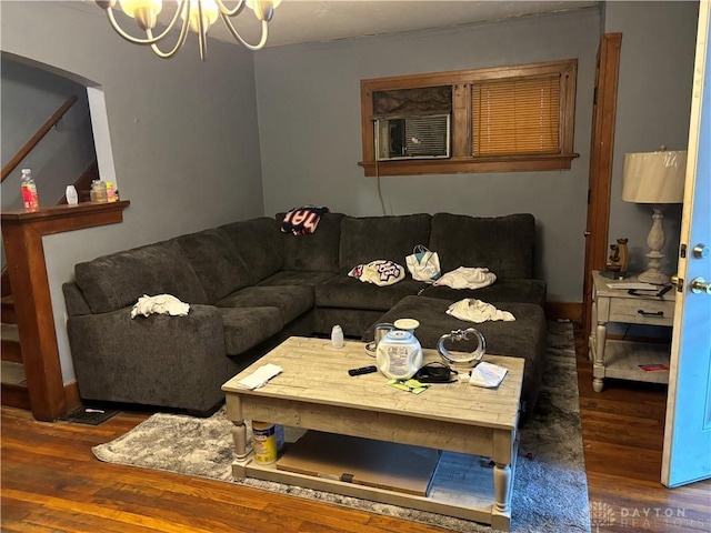 living room featuring a notable chandelier and wood finished floors