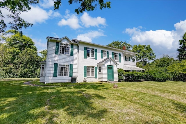 colonial-style house with a front lawn