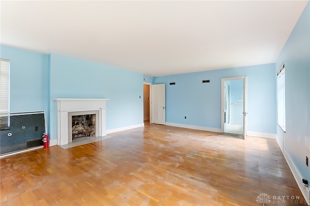 unfurnished living room with hardwood / wood-style flooring