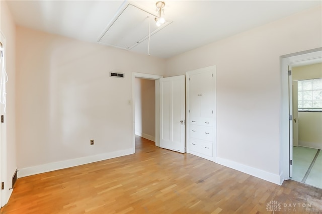 unfurnished bedroom with light wood-type flooring