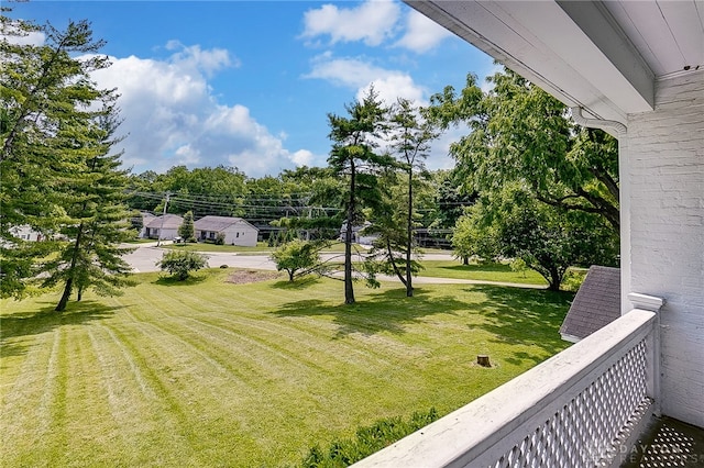 view of yard with a balcony