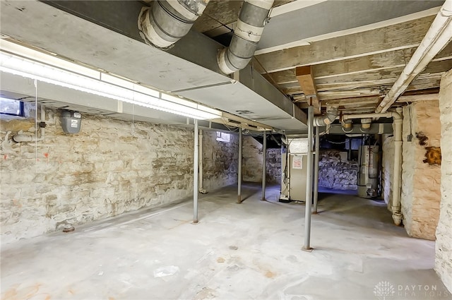 basement featuring gas water heater and heating unit