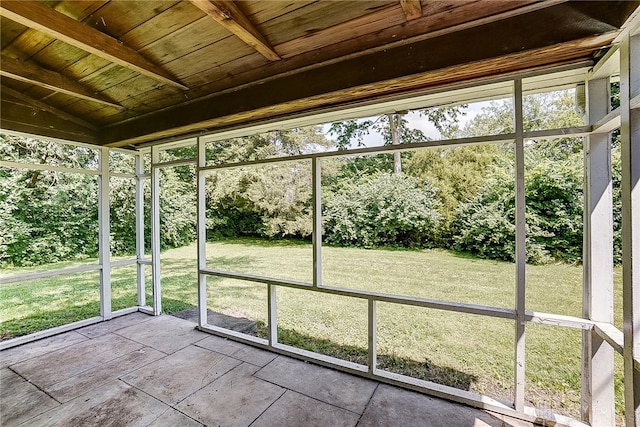 unfurnished sunroom featuring lofted ceiling and wooden ceiling