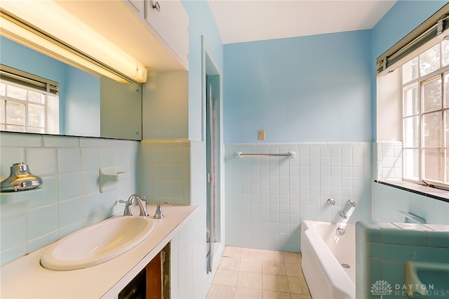 bathroom with tile patterned floors, plenty of natural light, and tile walls