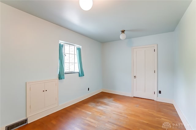 empty room with hardwood / wood-style floors