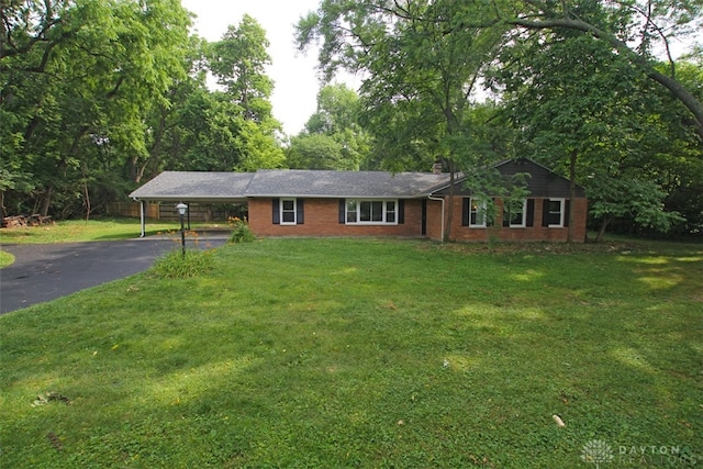 ranch-style house with a carport and a front lawn