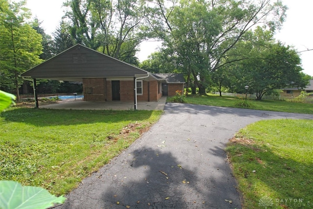 view of front of property with a carport and a front yard