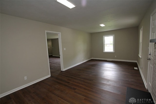 empty room with dark wood-type flooring